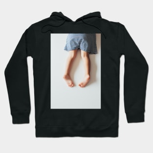 Legs of Small Girl Lying on White Tabletop Hoodie